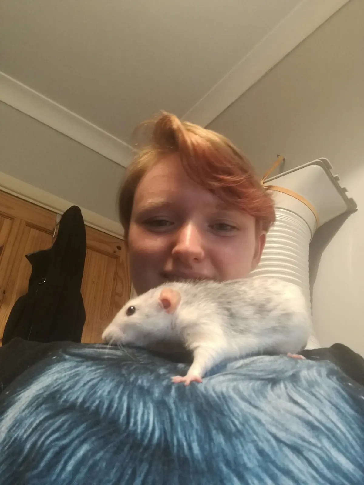 Leia with a friendly pet rat resting on her shoulder